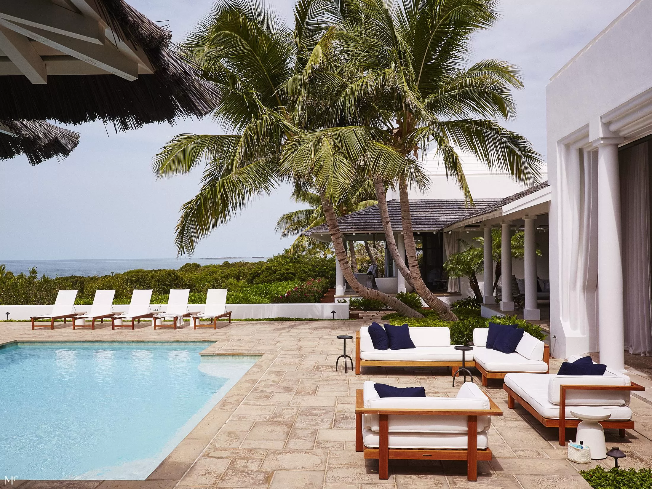 backyard pool of a view of palm trees and beach chairs