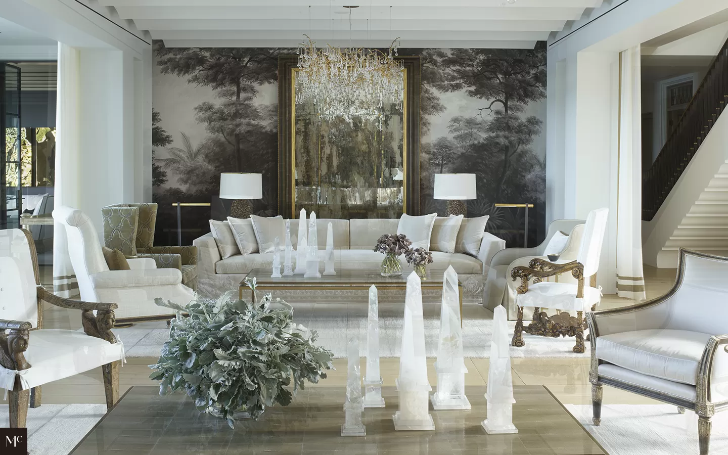 Living room with light wood floors, tall windows, and white walls