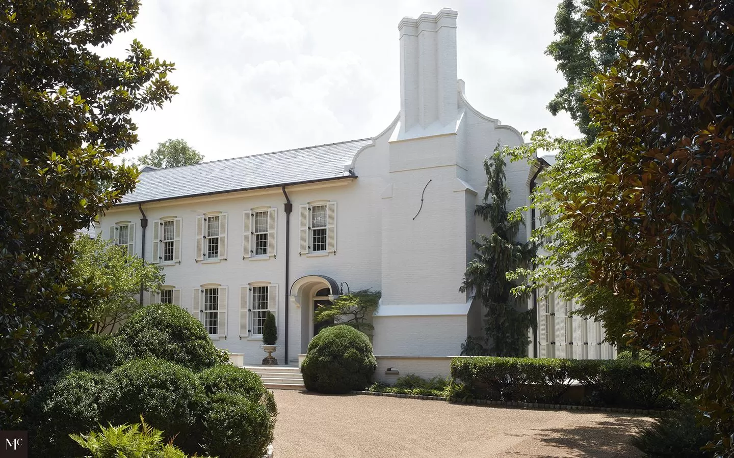 A large white house with double windows and shutters