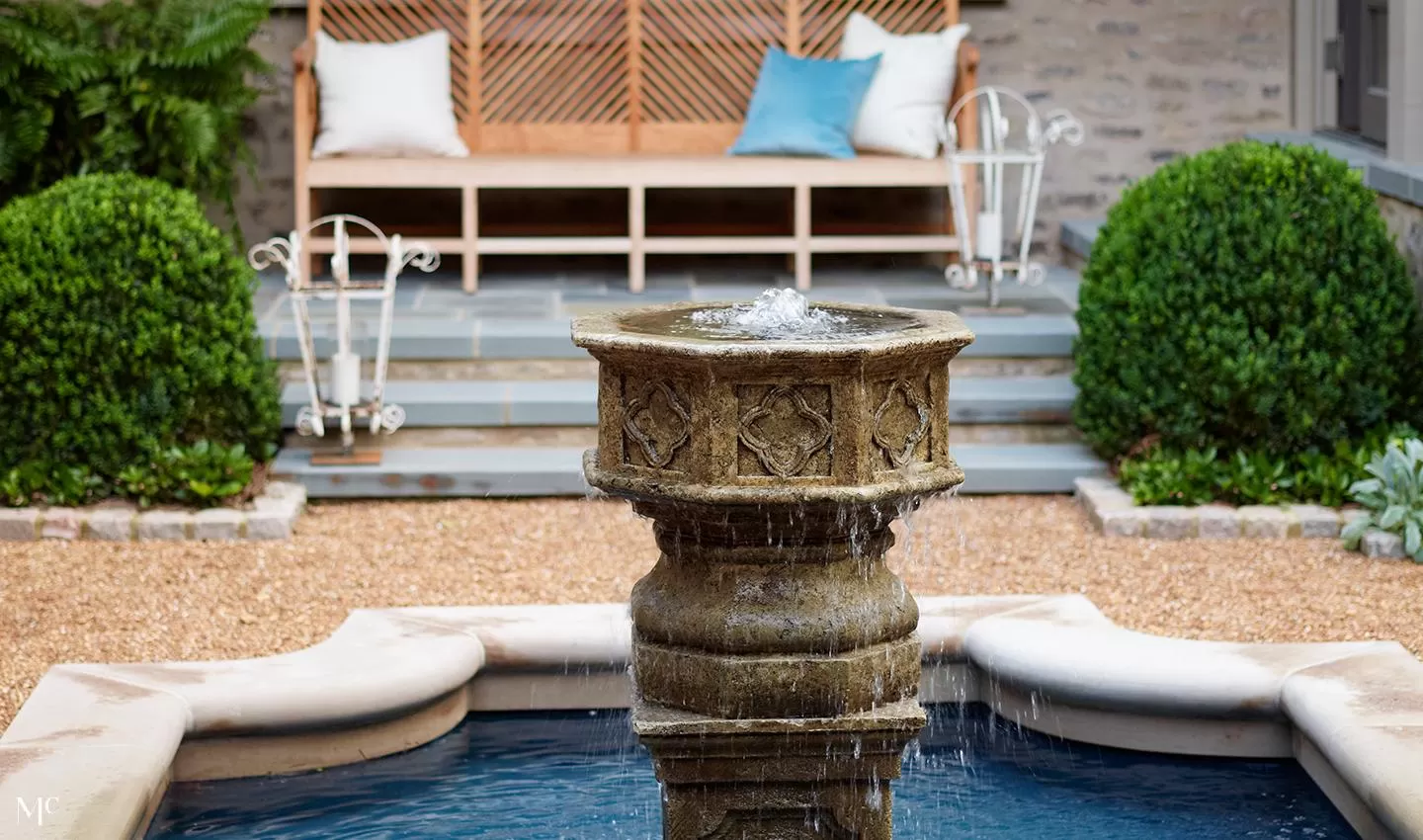 Back patio of a stone fountain