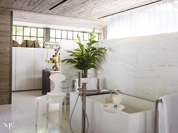 A clean white modern bathroom with greeneries and sculptures