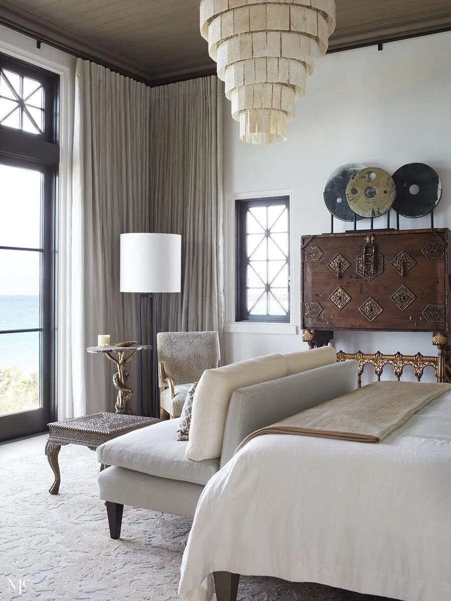 Floor to ceiling windows looking out to the ocean, with neutral palette and organic textures.