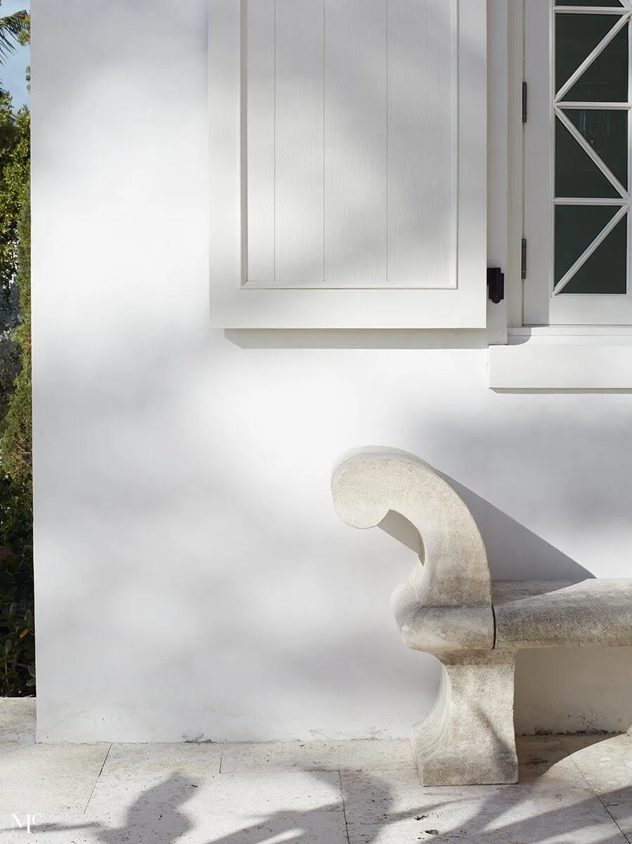 white exterior of a beach house with white granite furniture