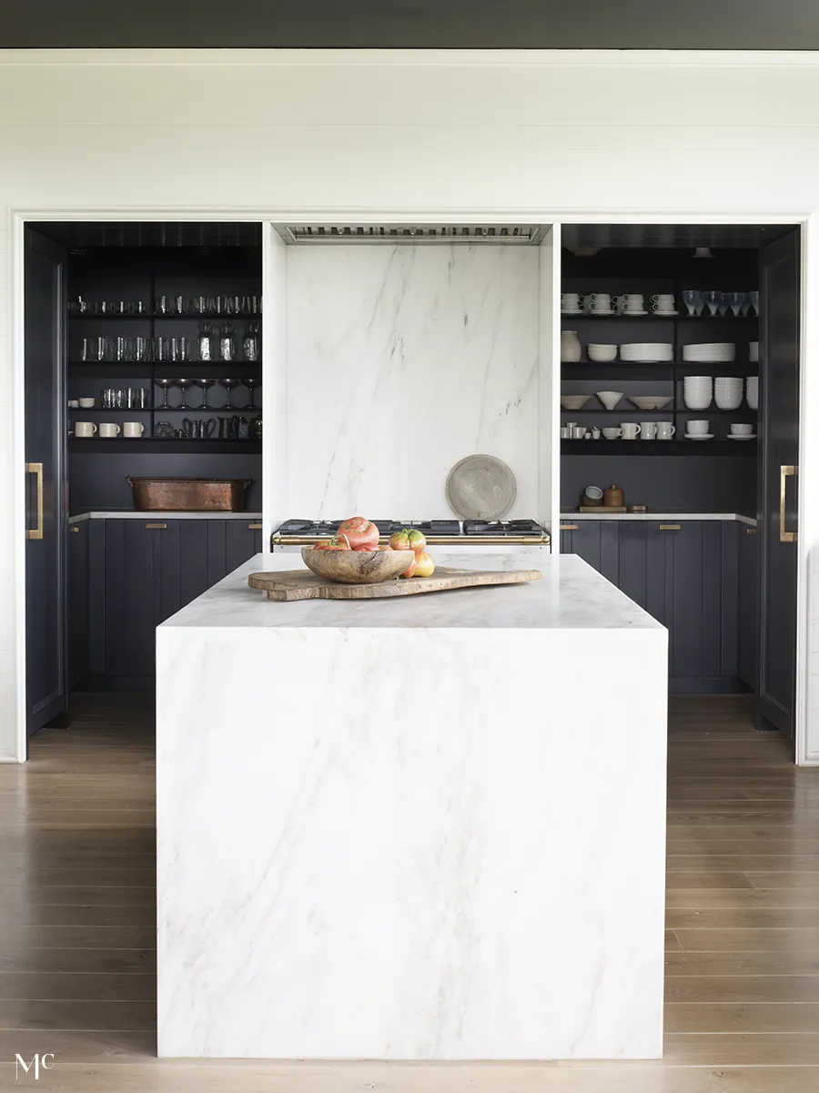 white marble interiors and countertops with black cabinets