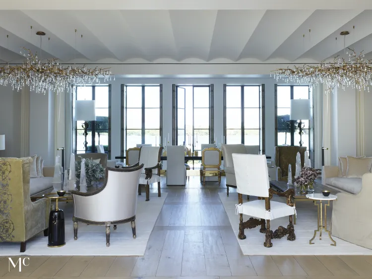 Living room with light wood floors, tall windows, and white walls