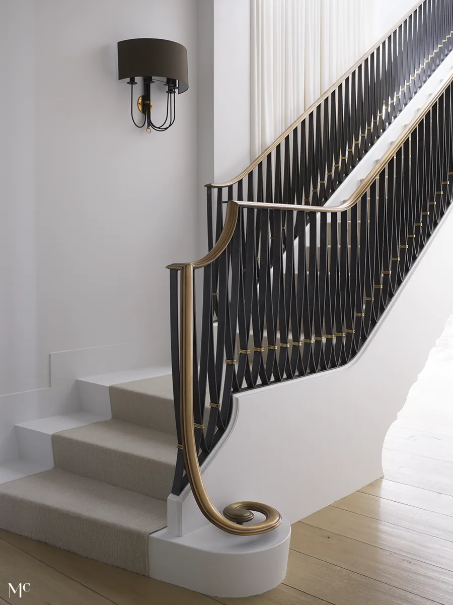 white stairs on wood floors and black railings