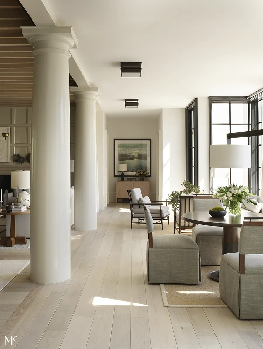 white living room with neutral tones and large columns