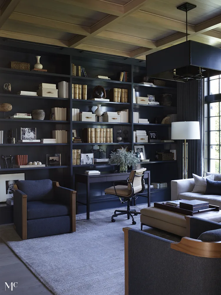 A reading room with dark blue bookshelves