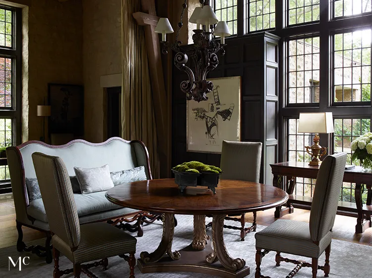 elegant home office with long curtains, fireplace and dining table in the style of tuscany stone walls and cream colored linen drapes