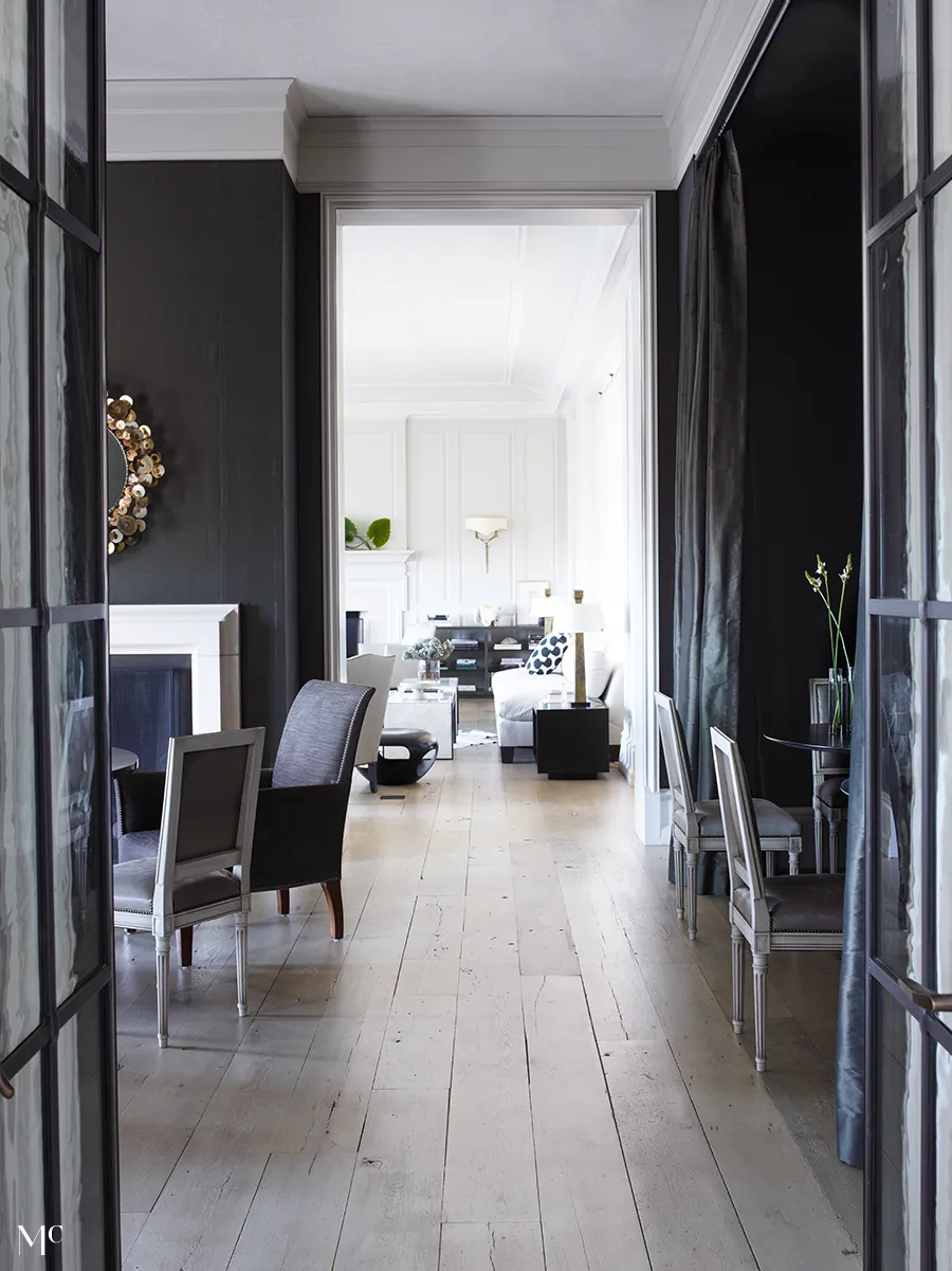 A large hallway with black walls, white and silver accents