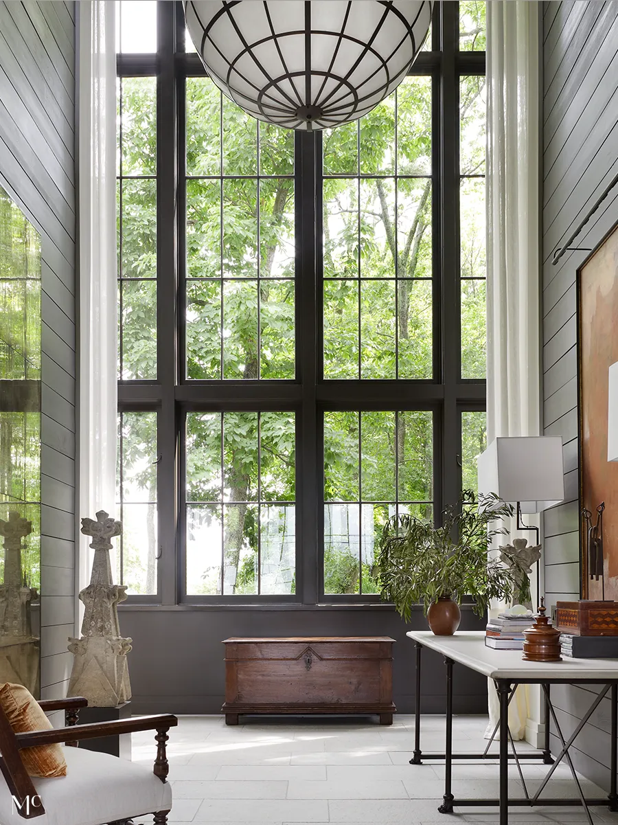 A modern farmhouse-style living room with large windows