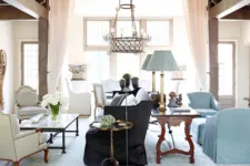 Elegant living room in the style of English country style, with a light blue sofa and armchair, a wooden coffee table on the left side, a grey carpet floor, tall windows