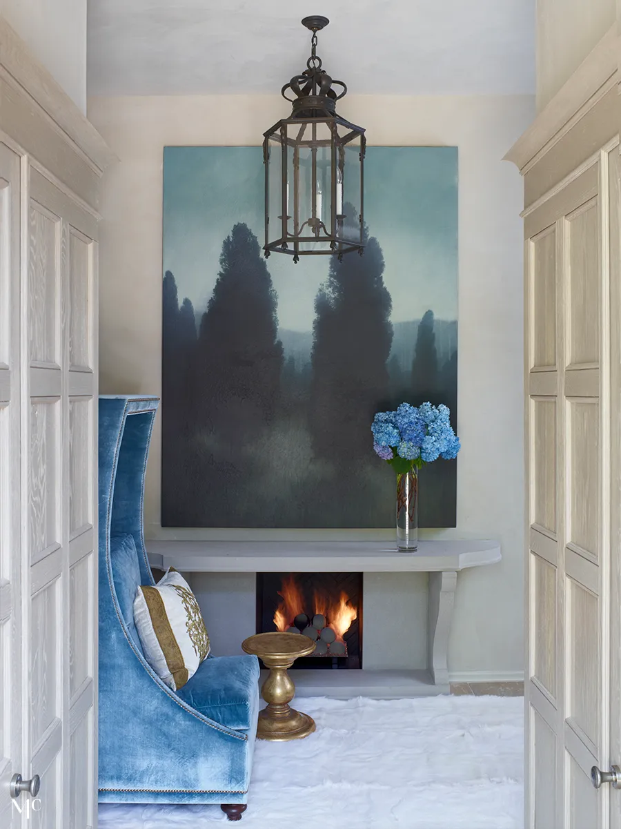 Elegant living room in the style of English country style, with a light blue sofa and armchair, a wooden coffee table on the left side, a grey carpet floor, tall windows, a large window overlooking the garden, dark oak paneled walls, a modern art painting hanging above the door frame, and black metal accents