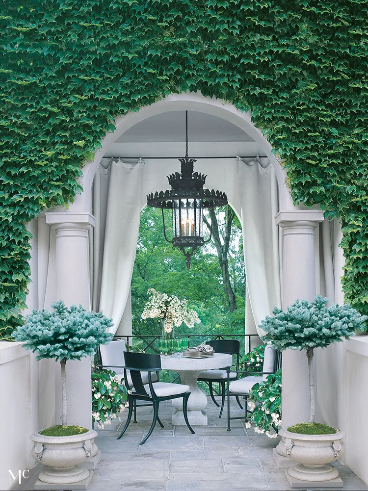 A white archway with green ivy on the sides