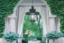 A white archway with green ivy on the sides