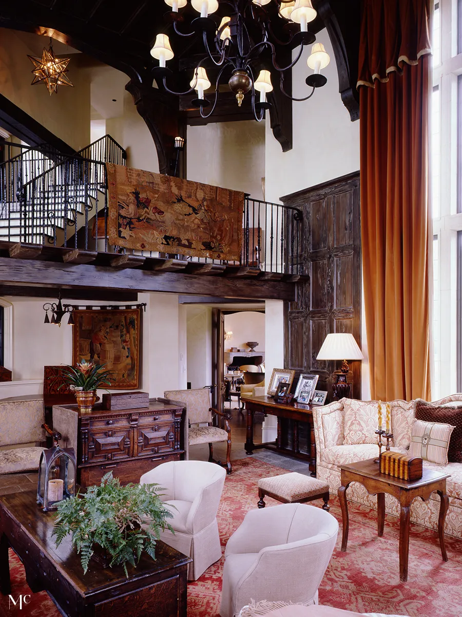 room with tall arched ceilings and white walls, dark wood floors